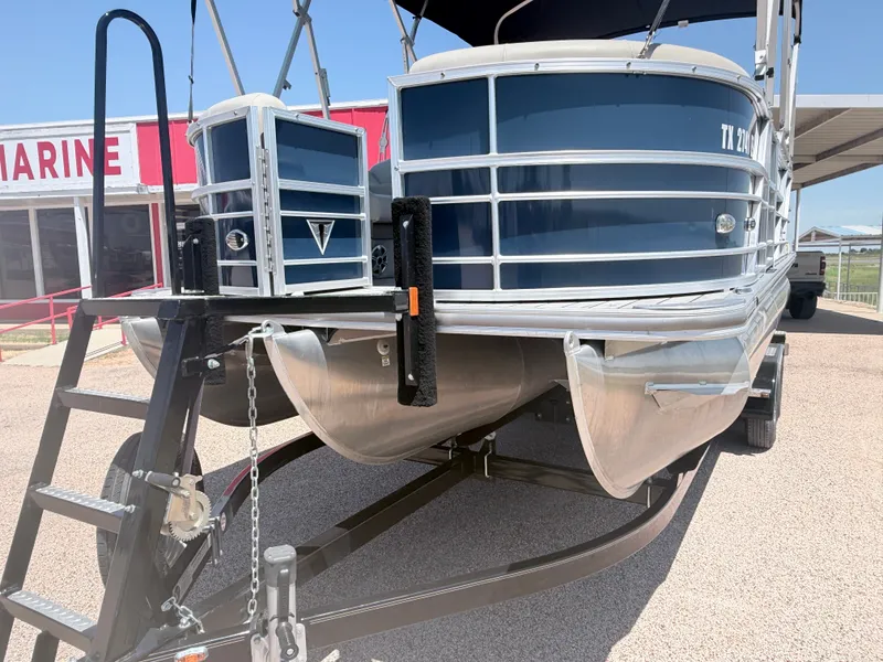 Slide: The Image of A 2018 Trifecta pontoon boat on a trailer, featuring blue paneling and silver details. - 4