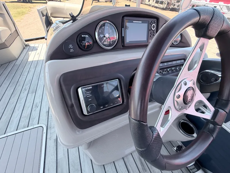 Slide: The Image of The image shows the helm of a 2018 Trifecta boat with modern instruments and a sleek steering wheel. - 21