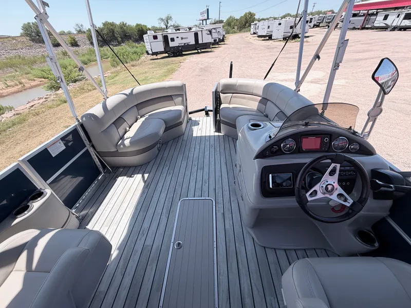 Slide: The Image of The image shows the spacious deck of a 2018 Trifecta pontoon boat with comfortable seating. - 13