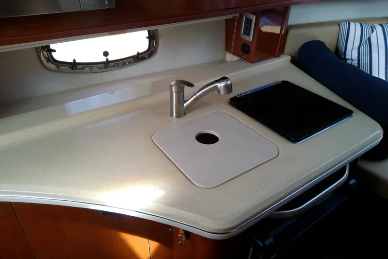 Slide: The Image of Interior view of 2012 Sea Ray Sundancer 280 kitchen area with sink and countertop. - 37