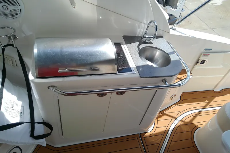 Slide: The Image of Outdoor kitchenette on 2012 Sea Ray Sundancer 280 with grill and sink. - 18