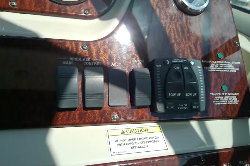 Slide: The Image of Control panel of a 2012 Sea Ray Sundancer 280 boat with switches and caution label. - 28