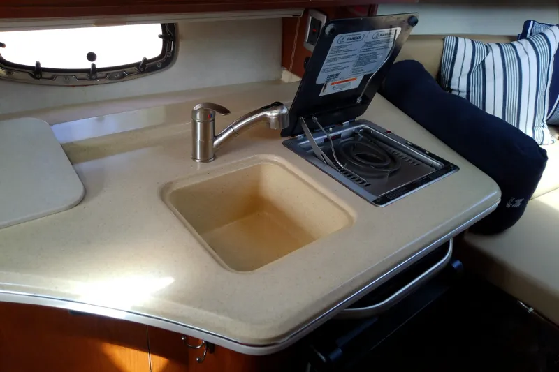 Slide: The Image of Compact kitchen area in 2012 Sea Ray Sundancer 280 yacht with sink and stove. - 39