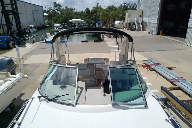 Slide: The Image of 2012 Sea Ray Sundancer 280 docked at marina, featuring open cockpit and sleek design. - 32