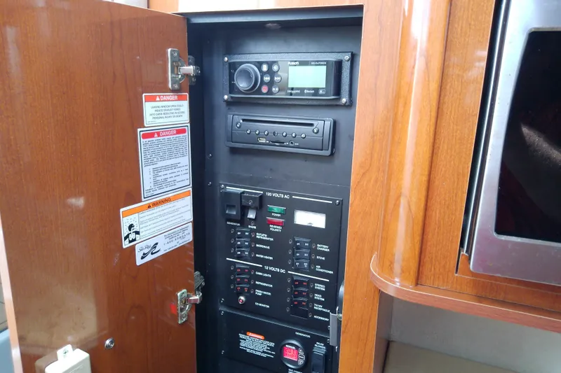 Slide: The Image of Electrical control panel inside a 2012 Sea Ray Sundancer 280 boat cabin. - 48