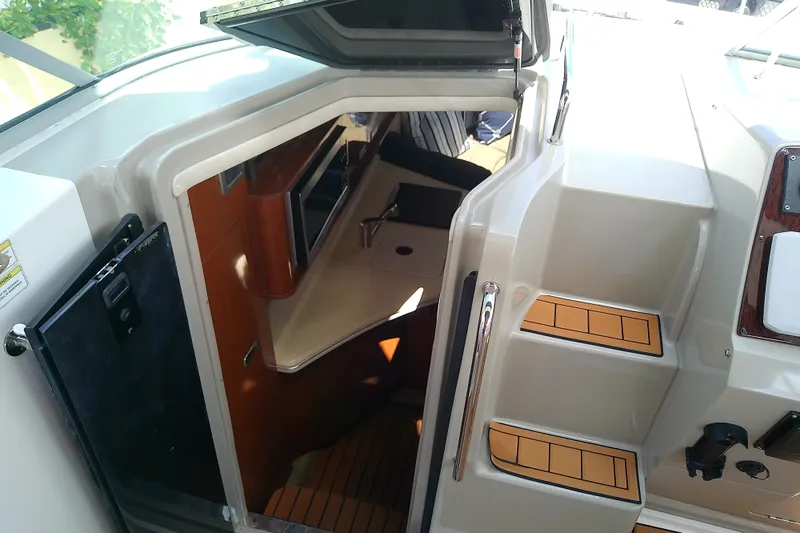Slide: The Image of Interior view of 2012 Sea Ray Sundancer 280 cabin entrance with steps and kitchenette. - 35