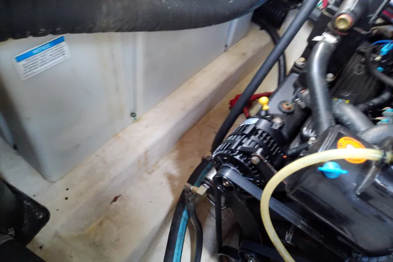 Slide: The Image of Engine compartment of a 2012 Sea Ray Sundancer 280 boat, showing mechanical components. - 57