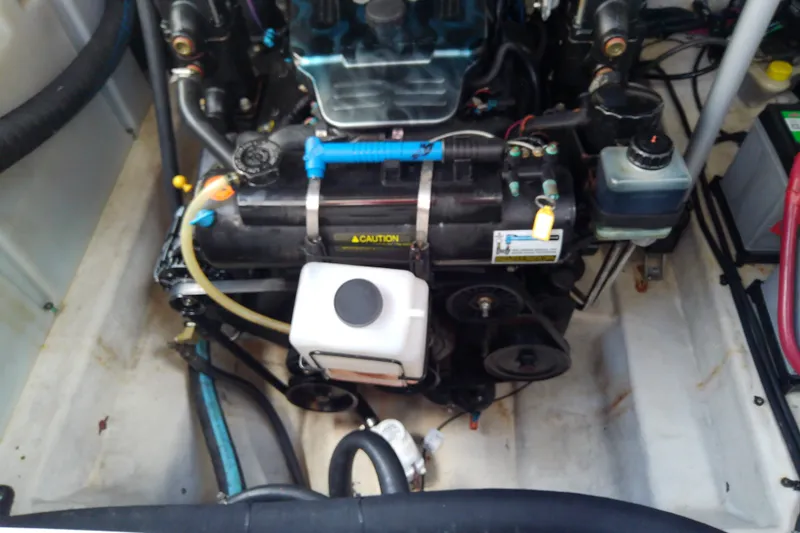 Slide: The Image of Engine compartment of a 2012 Sea Ray Sundancer 280 boat, showcasing mechanical components. - 50