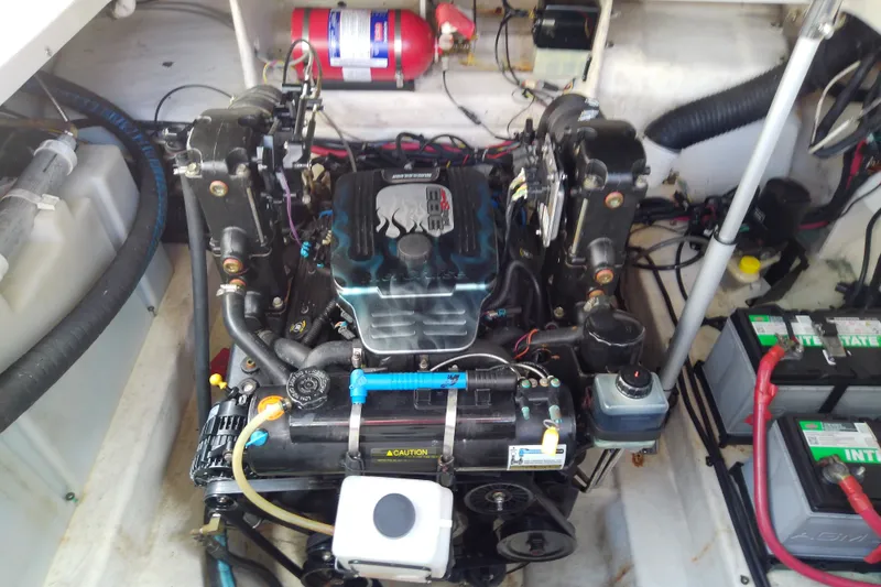 Slide: The Image of Engine compartment of a 2012 Sea Ray Sundancer 280 with visible components and wiring. - 49