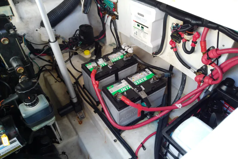 Slide: The Image of Engine compartment of a 2012 Sea Ray Sundancer 280 with batteries and wiring. - 51