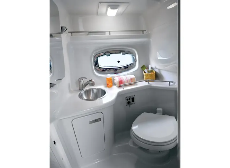 Slide: The Image of Manufacturer Provided Image: 2012 Sea Ray 280 Sundancer bathroom with sink, toilet, and porthole window. - 66