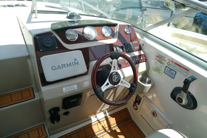 Slide: The Image of Cockpit of 2012 Sea Ray Sundancer 280 with Garmin navigation system and wood-accented steering wheel. - 20