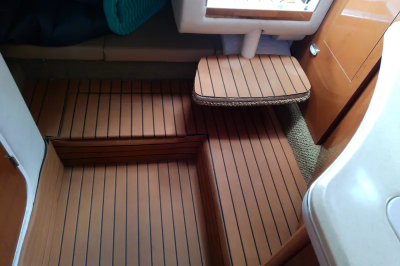 Slide: The Image of Interior of 2012 Sea Ray Sundancer 280 with wooden flooring and compact design. - 45