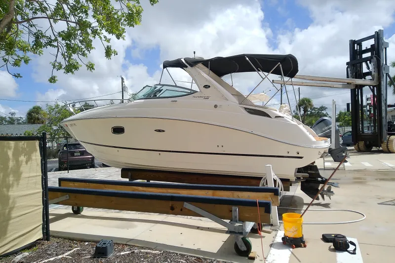The Image of 2012 Sea Ray Sundancer 280 boat on trailer under a clear sky. - 0
