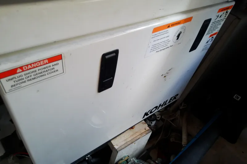 Slide: The Image of Kohler generator in a 2012 Sea Ray Sundancer 280, featuring safety warning labels. - 54