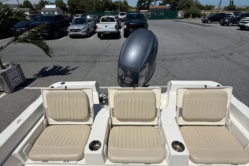 Slide: The Image of 2012 NauticStar 210 Coastal boat with beige seating and Yamaha outboard motor. - 14