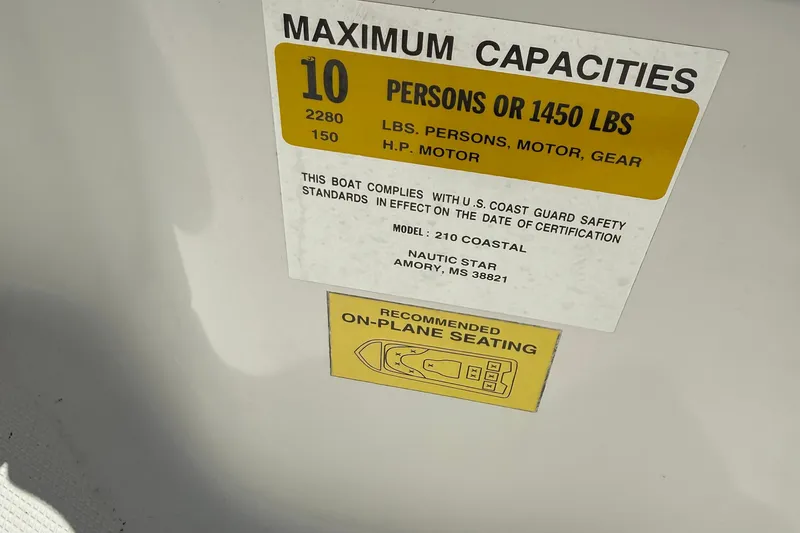 Slide: The Image of 2012 NauticStar 210 Coastal capacity label, 10 persons or 1450 lbs, U.S. Coast Guard compliant. - 17