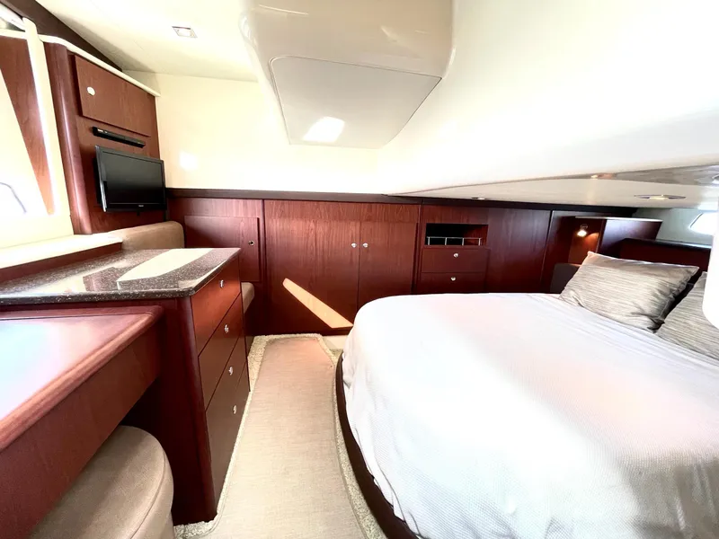 Slide: The Image of Luxurious interior of a 2012 Meridian 441 Sedan yacht with elegant wood finishes. - 30