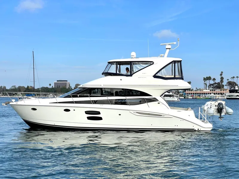 The Image of 2012 Meridian 441 Sedan yacht cruising on calm waters under a clear blue sky. - 0