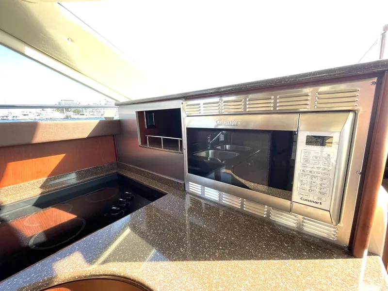 Slide: The Image of Modern kitchen area in a 2012 Meridian 441 Sedan yacht with microwave and stovetop. - 20