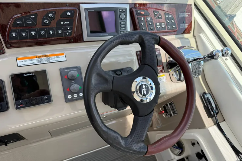 Slide: The Image of 2008 Sea Ray Sundancer 350 helm with steering wheel and control panel. - 19