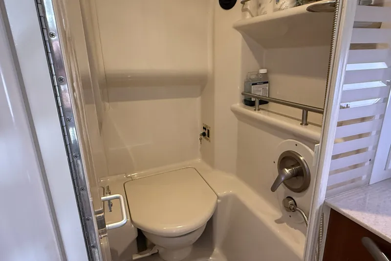 Slide: The Image of Compact bathroom in 2008 Sea Ray Sundancer 350 yacht with toilet and shelves. - 24