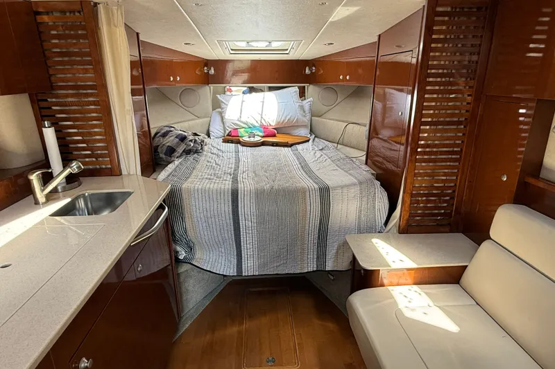 Slide: The Image of Luxurious interior of 2008 Sea Ray Sundancer 350 yacht with cozy bed and kitchenette. - 25