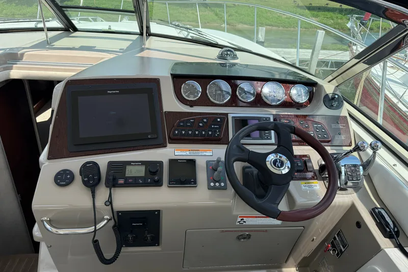 Slide: The Image of Cockpit of 2008 Sea Ray Sundancer 350 with steering wheel and navigation controls. - 14