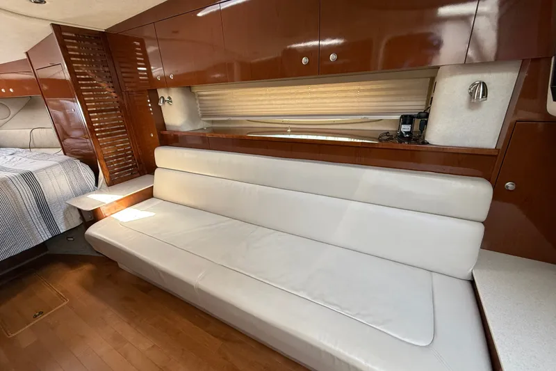 Slide: The Image of Interior of 2008 Sea Ray Sundancer 350 with white leather seating and wooden cabinetry. - 27
