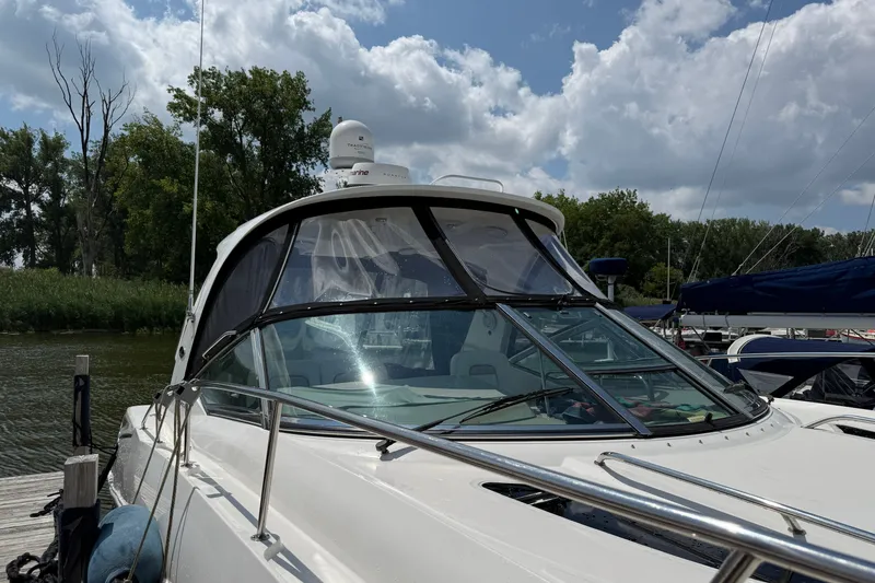 Slide: The Image of 2008 Sea Ray Sundancer 350 yacht docked, surrounded by trees and cloudy sky. - 5