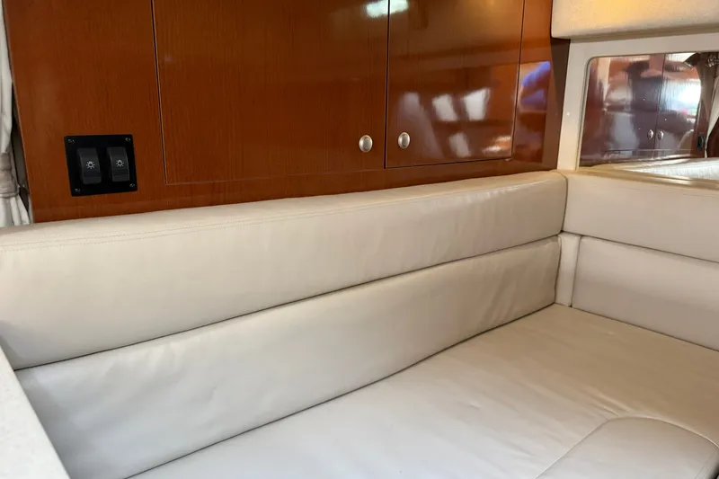 Slide: The Image of Interior of 2008 Sea Ray Sundancer 350 with beige seating and wooden cabinetry. - 30