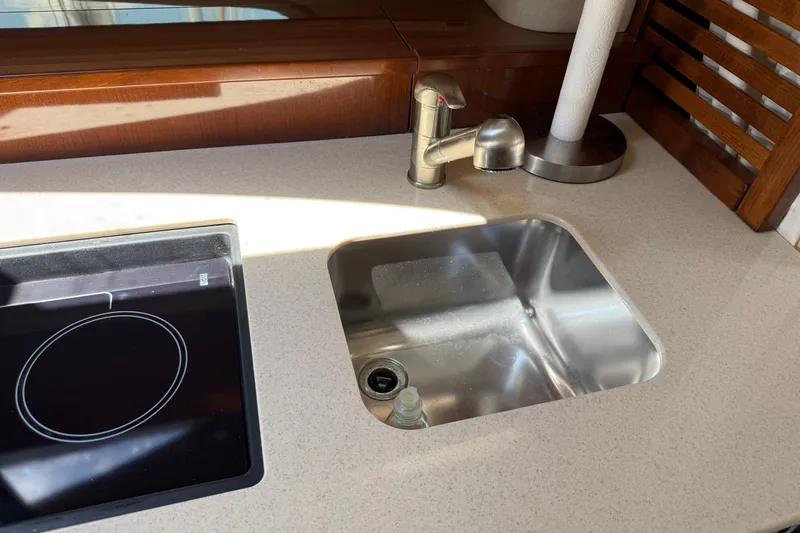 Slide: The Image of Kitchen area of 2008 Sea Ray Sundancer 350 with sink and stovetop. - 32