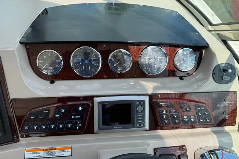 Slide: The Image of Dashboard of a 2008 Sea Ray Sundancer 350 boat with gauges and controls. - 18