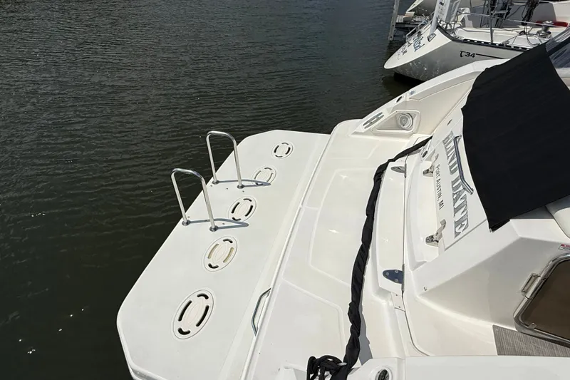 Slide: The Image of 2008 Sea Ray Sundancer 350 yacht docked, featuring swim platform and ladder. - 7