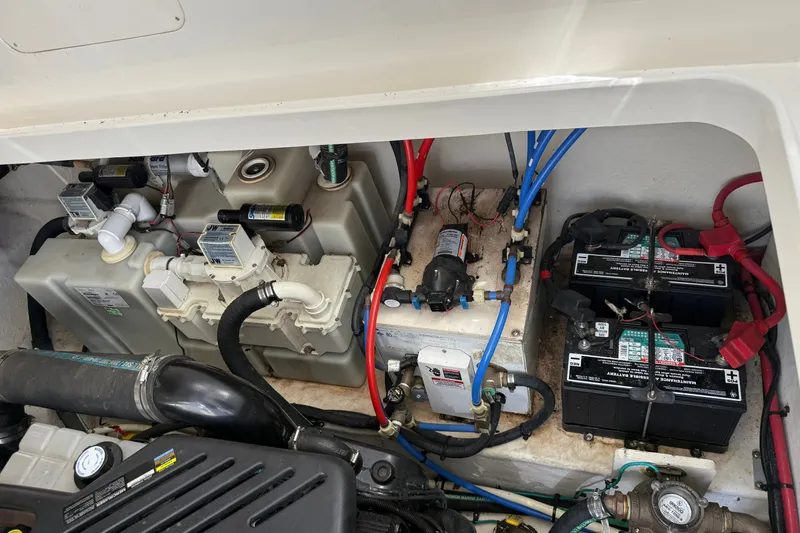 Slide: The Image of Engine compartment of a 2008 Sea Ray Sundancer 350 with batteries and plumbing components. - 37