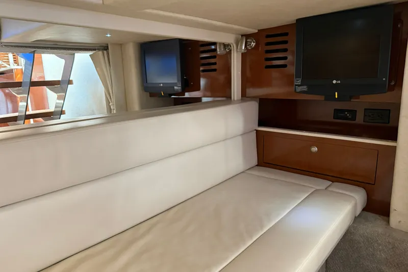 Slide: The Image of Interior of 2008 Sea Ray Sundancer 350 with white seating and mounted TV. - 29