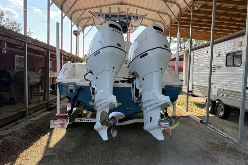 Slide: The Image of 2026 Bulls Bay 255 Center Console boat with dual outboard motors in covered storage. - 19