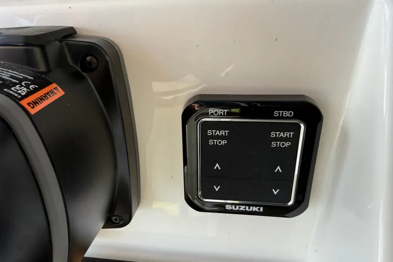 Slide: The Image of Control panel of a 2026 Bulls Bay 255 Center Console boat with Suzuki engine controls. - 17