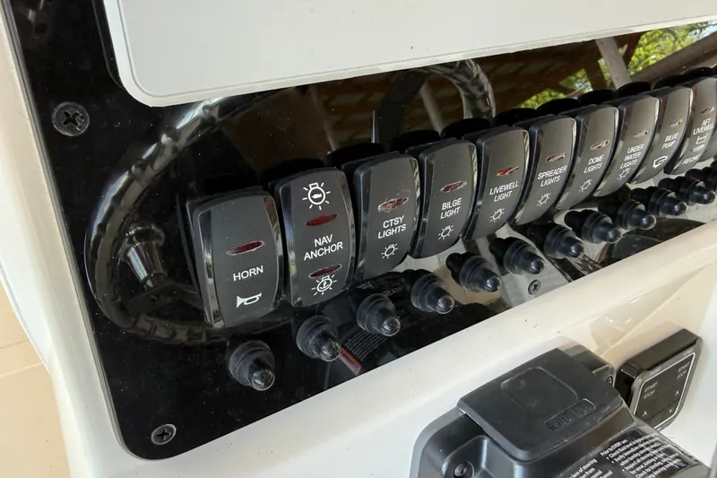 Slide: The Image of Control panel of 2026 Bulls Bay 255 Center Console boat with labeled switches. - 14