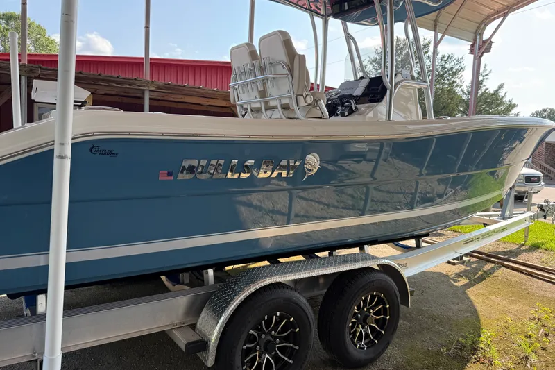 Slide: The Image of 2026 Bulls Bay 255 Center Console boat on trailer, blue hull, outdoor setting. - 22