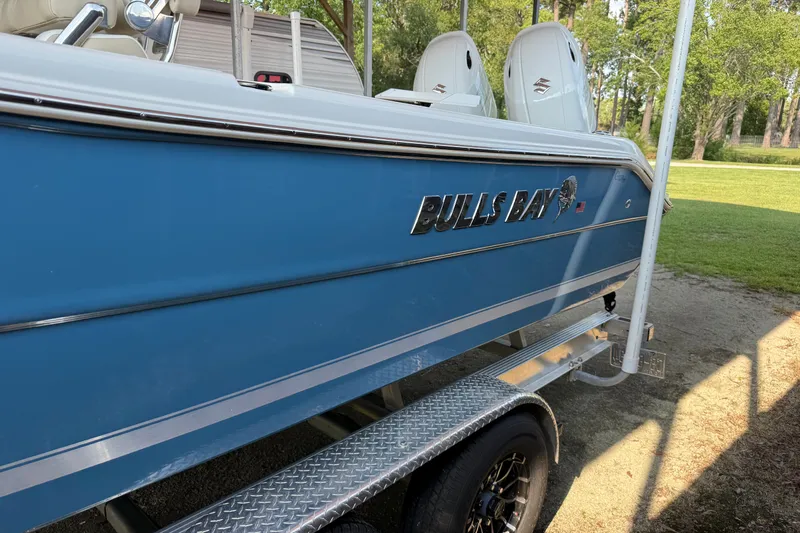 Slide: The Image of 2026 Bulls Bay 255 Center Console boat on trailer, side view in outdoor setting. - 3
