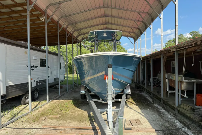 Slide: The Image of 2026 Bulls Bay 255 Center Console boat on trailer under metal canopy. - 2