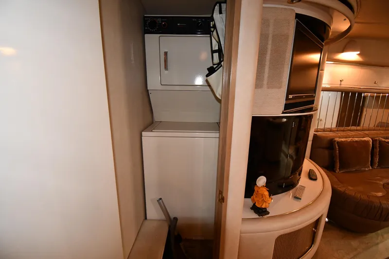 Slide: The Image of Interior of 1995 Sea Ray 630 Sundancer with washer, dryer, and cozy seating area. - 60
