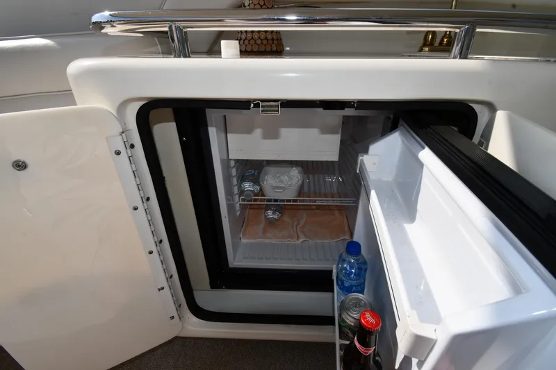 Slide: The Image of Mini fridge on 1995 Sea Ray 630 Sundancer yacht, stocked with drinks and snacks. - 27
