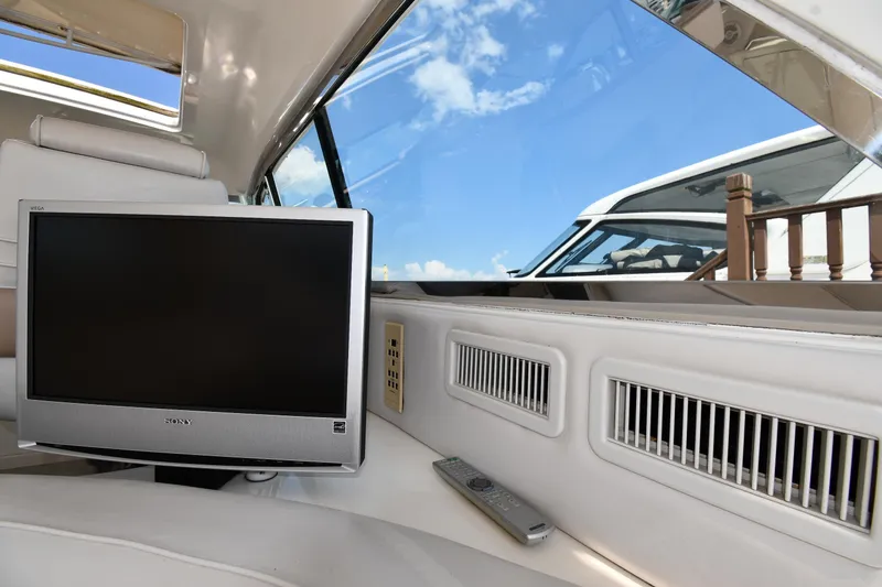 Slide: The Image of Interior of 1995 Sea Ray 630 Sundancer yacht with TV and remote control. - 32
