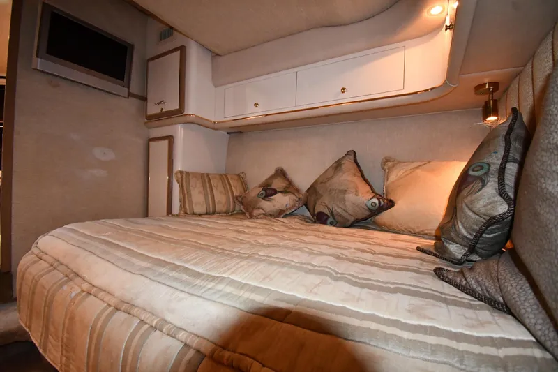 Slide: The Image of Luxurious cabin interior of 1995 Sea Ray 630 Sundancer yacht with cozy bedding. - 63