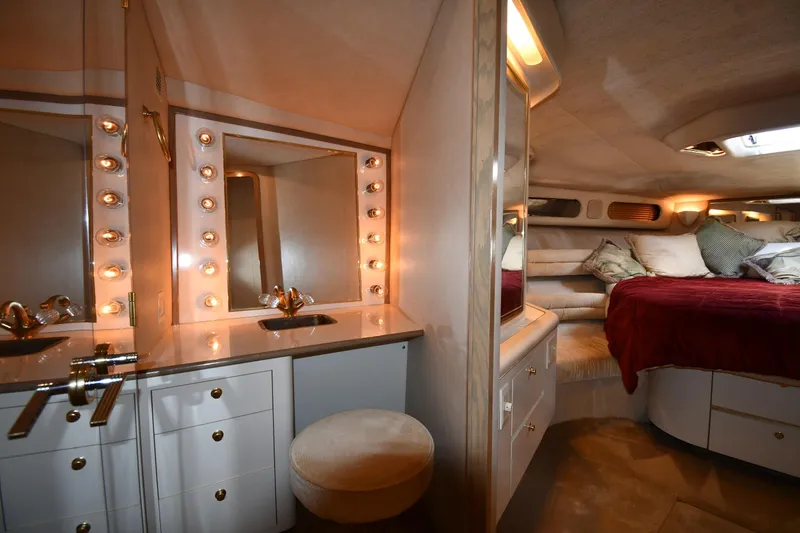 Slide: The Image of Luxurious 1995 Sea Ray 630 Sundancer cabin with vanity and cozy bed. - 49