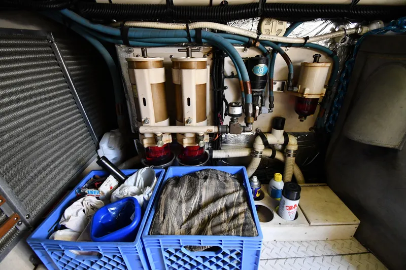 Slide: The Image of Engine room of 1995 Sea Ray 630 Sundancer with filters, hoses, and storage crates. - 77