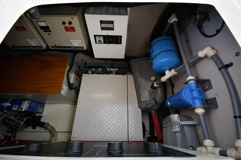 Slide: The Image of Engine room of 1995 Sea Ray 630 Sundancer with control panels and plumbing systems. - 86