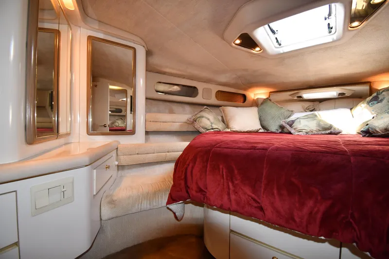 Slide: The Image of Luxurious cabin interior of 1995 Sea Ray 630 Sundancer with plush bedding and mirrors. - 43